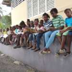 Photo of children who read next to a motolibrary in Haiti
